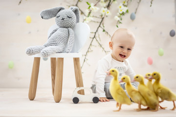 Yellow fluffy ducklings. Easter composition. The little smiling child boy with ducklings © Надія Коваль