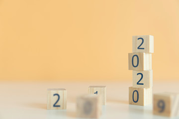 Wooden cubes on table with New year 2020 concept.