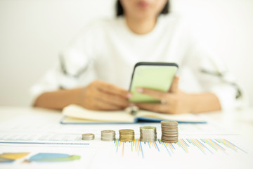 concept saving money and finance accounting. Growth investment and saving growth stacking coin money with woman calculate and analysis or financial costs