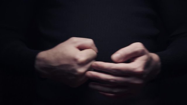 Close-up man beats his fist in the palm, isolate on black background