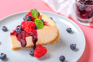 Classic plain New York Cheesecake looks delicious on plates and pastel colored backgrounds.