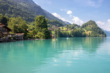 Fototapeta na wymiar The town on the shores of turquoise lake, Switzerland