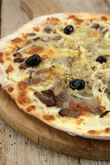 pizza with kebab and mozzarella on a wooden table