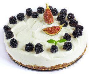 Raw vegan cashew nutty coconut cheesecake with blackberry and mint isolated on white background, copy space. Raw desserts for vegans concept.