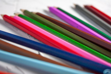 Fototapeta premium Set of colored pencils on a white on concrete or plastered background.