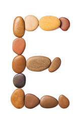 Letter E made of marine small pebbles, top view. Alphabet made of stones Isolated on a white background