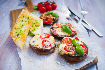 Grilled champignon portobello stuffed with mozzarella, cherry tomatoes and basil with garlic herb baguette
