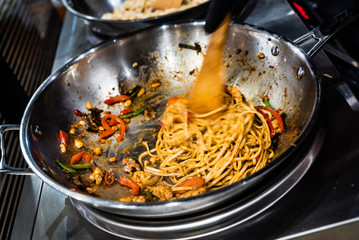 chef cooking noodles in the restaurant