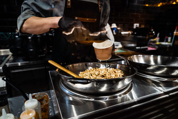 chef cooking noodles in the restaurant