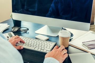 Close up of a businessman at his working table in office