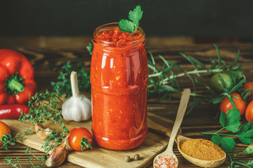Homemade DIY natural canned hot tomato sauce chutney with chilli or adjika