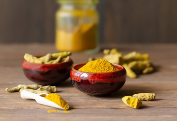 Turmeric powder and roots, healthy healing spice, commonly used in Indian and Asian cuisine