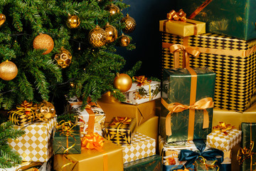 Pile of wrapped green and gold presents for Christmas