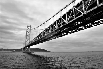 Japanese bridge to island in black and white
