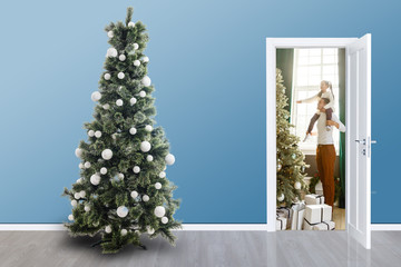 Close up of open wooden door Christmas tree