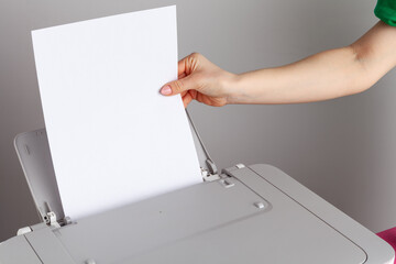 Close up of woman using a printer machine
