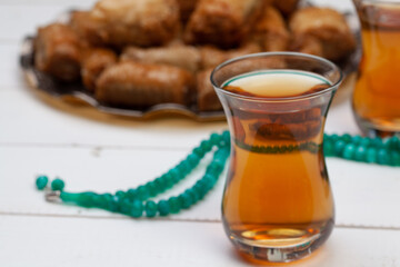 Cup of hot tea and a plate of turkish desserts