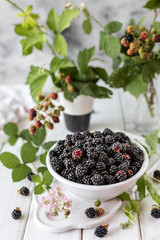 Fototapeta na wymiar Fresh ripe blackberry in a ceramic cup.