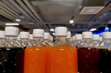 plastic bottles in a row with industrial background