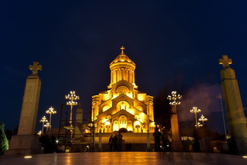 Obraz premium Wokół widok katedry Świętej Trójcy w Tbilisi (Sameba) i budynków w starym Tbilisi w nocy