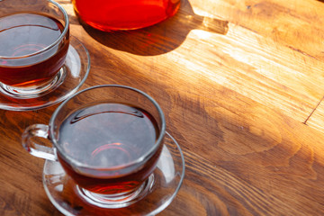 Hot cup of tea on wooden rustic table close up