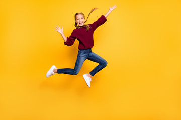Fototapeta na wymiar Full length body size view of her she nice attractive careless cheerful cheery playful pre-teen girl having fun jumping weekend free time isolated on bright vivid shine vibrant yellow color background