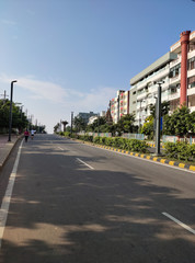 City road along with building and green trees.
