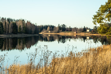 Fototapeta premium Beautiful autumn landscape of Kymijoki river waters at sunset. Finland, Kymenlaakso, Kouvola