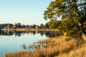 Fototapeta premium Beautiful autumn landscape of Kymijoki river waters at sunset. Finland, Kymenlaakso, Kouvola