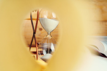 Close up of book page on a background of hourglass