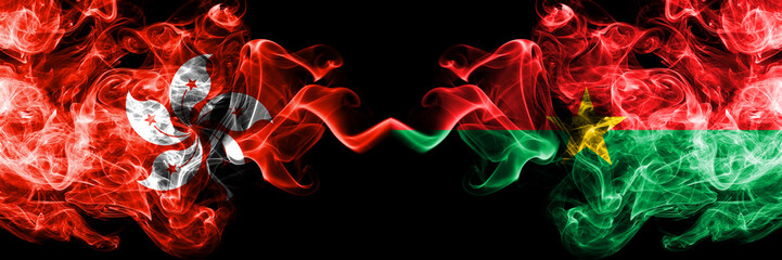 Fototapeta premium Hong Kong, China vs Burkina Faso smoky mystic states flags placed side by side. Concept and idea thick colored silky abstract smoke flags