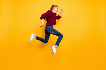 Fototapeta na wymiar Full length body size view of nice attractive overjoyed cheerful cheery crazy pre-teen girl having fun jumping running isolated over bright vivid shine vibrant yellow color background