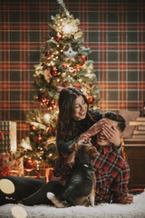 Young couple celebrating Christmas in under the tree