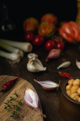 Vegetable assortment, lentils, chickpeas on brown wooden table, top view