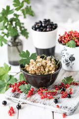 Fresh currants in a ceramic cup: black currants, red currants and white currants