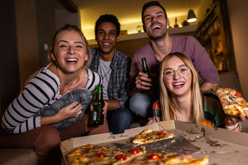 Group best friends sitting at home  watching a comedy movie .Watching tv show.