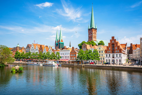 Classic panoramic view of historic skyline of hanseatic town of Lübeck with famous St. Mary's Church on a beautiful sunny day with blue sky in summer, Schleswig-Holstein, Germany