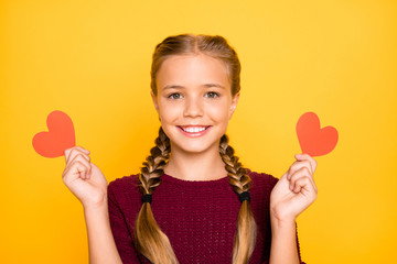 Close-up portrait of her she nice attractive lovely sweet cute cheerful cheery pre-teen girl holding in hands small heart cards isolated on bright vivid shine vibrant yellow color background