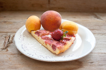 Round strawberry pie with fresh strawberries slice on plate dish on wooden table background
