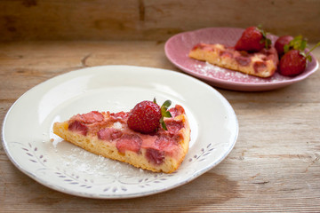 Round strawberry pie with fresh strawberries slice on plate dish on wooden table background