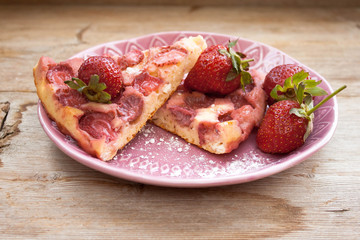 Round strawberry pie with fresh strawberries slice on plate dish on wooden table background