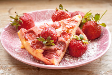 Round strawberry pie with fresh strawberries slice on plate dish on wooden table background