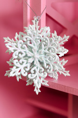 Large white snowflake on a pink background