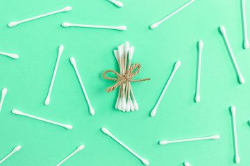 Paper cotton buds tied with twine and plastic cotton buds