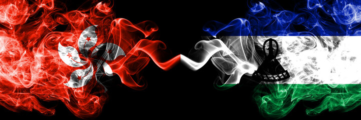 Hong Kong, China vs Lesotho smoky mystic states flags placed side by side. Concept and idea thick...