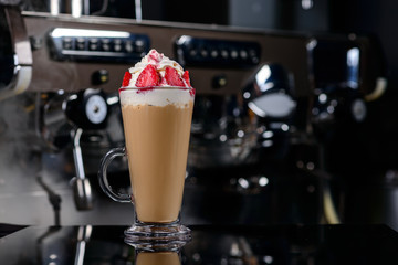 Iced coffee with milk and whipped cream and strawberries