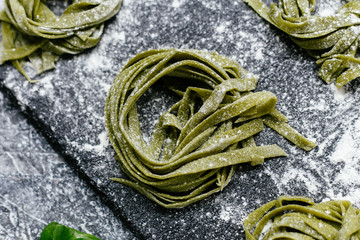  Spinach green pasta on a black slate plate