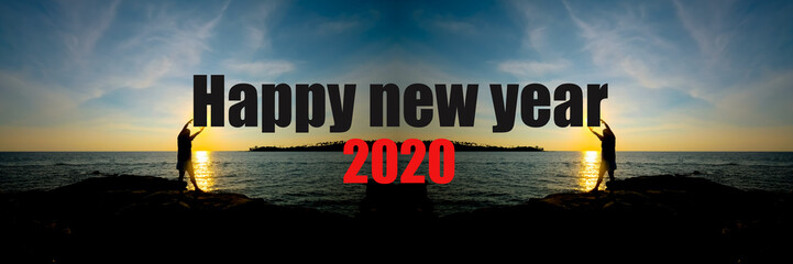 Happy new year 2020 concept with Silhouette of young girl holding the sun with beautiful sea and blue sky background