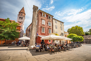 Beautiful panoramic view of idyllic scenery in the ancient roman city center of Zadar with historic church of St. Simeon on a beautiful sunny day with blue sky and clouds in summer, Dalmatia, Croatia - obrazy, fototapety, plakaty