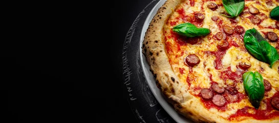 Gordijnen Delicious fresh pizza on a dark background. Italian food, copy space for text. Banner composition © VAKSMANV